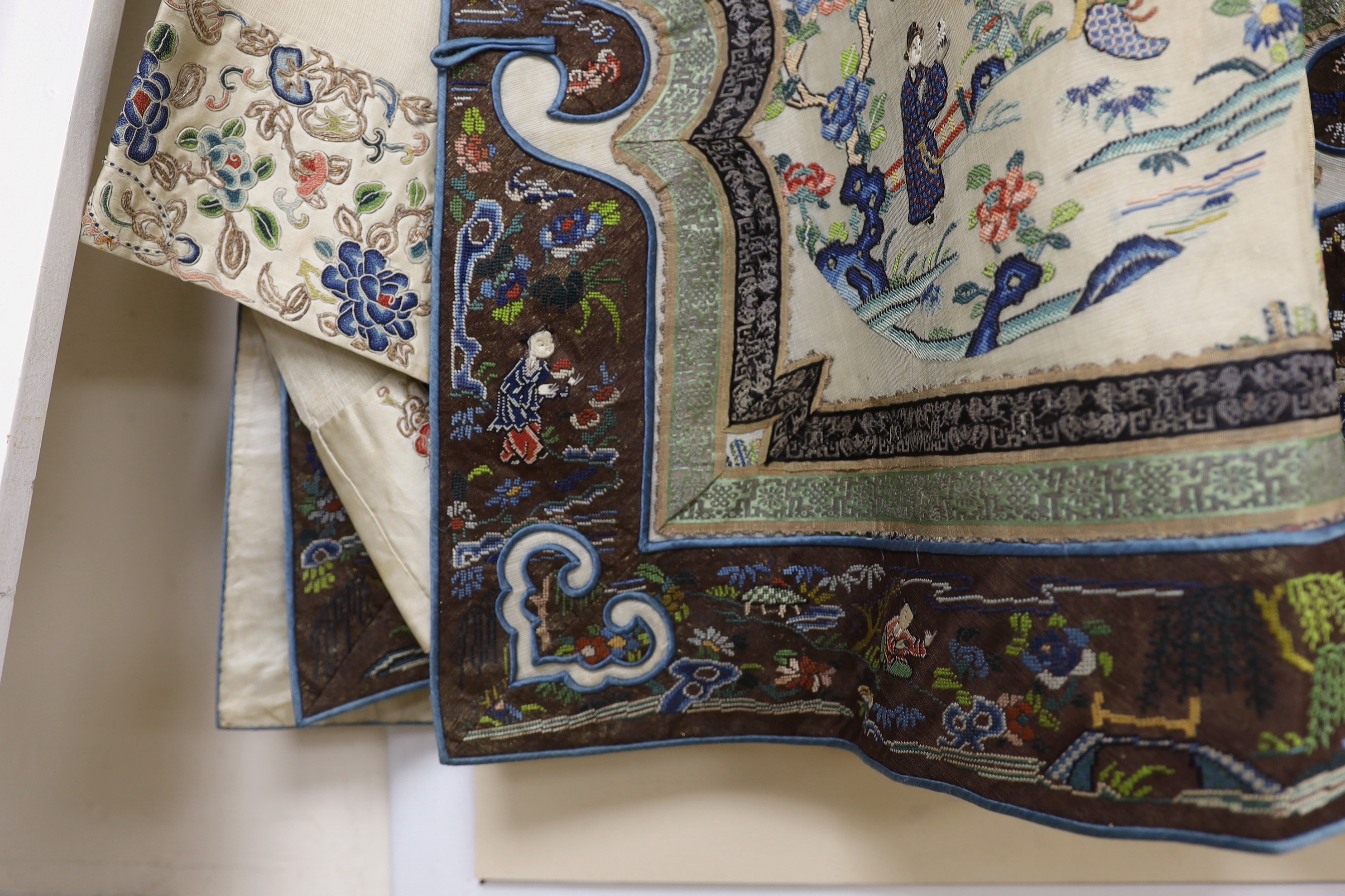A late 19th/early 20th century Chinese gauze summer robe embroidered with flowers, figures and pagodas, 85cm high